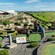 Two women and a boy playing mini golf on the top of a hilly course and a sign that says, ‘Par 3’